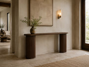 Epoque fluted oak console table in a warm residential entry