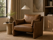 Zora nutmeg leather armchair with a brass floor lamp and stone side table